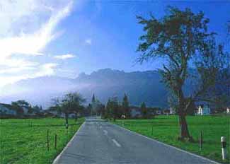 Ruggell's flat landscape framed by mountains